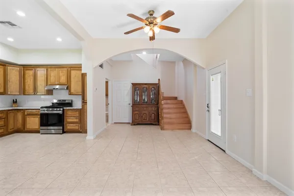 a kitchen with stainless steel appliances granite countertop a refrigerator and a stove top oven