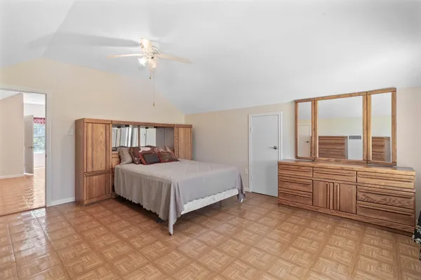 a spacious bedroom with a bed and a window