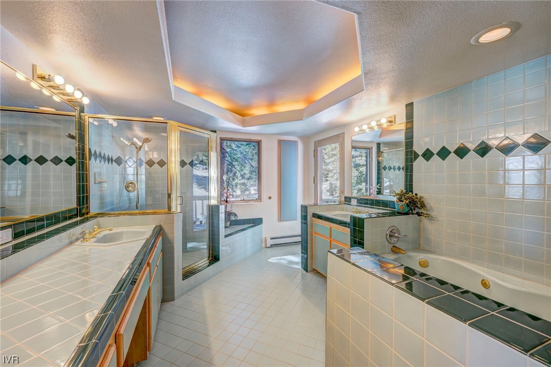 868 Tyner Way Incline Village, NV 89451 - Photo 21 of 25 a large bathroom with a tub a double vanity sink a mirror and a shower