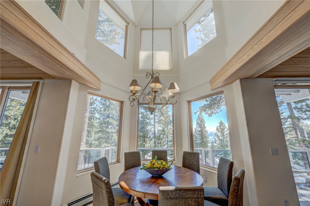 868 Tyner Way Incline Village, NV 89451 - Photo 8 of 25 a view of a dining room with furniture a chandelier and large window