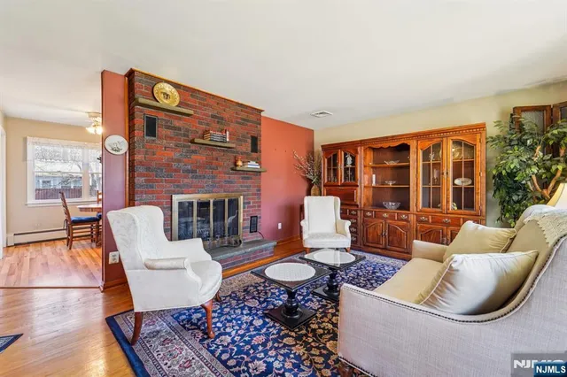 a living room with furniture a rug and a fireplace
