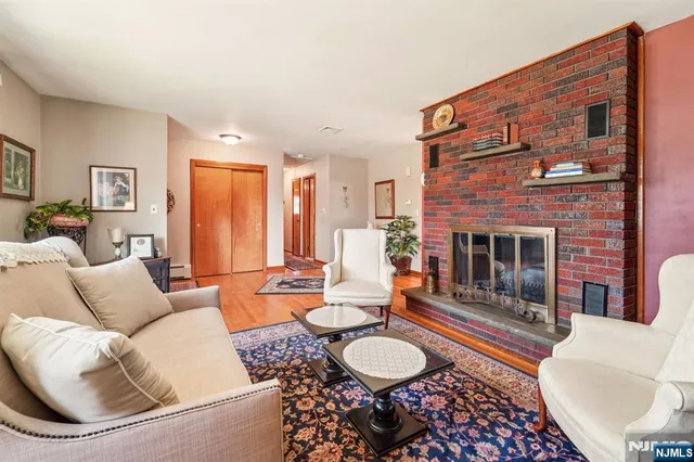 a living room with furniture a fireplace and a large window