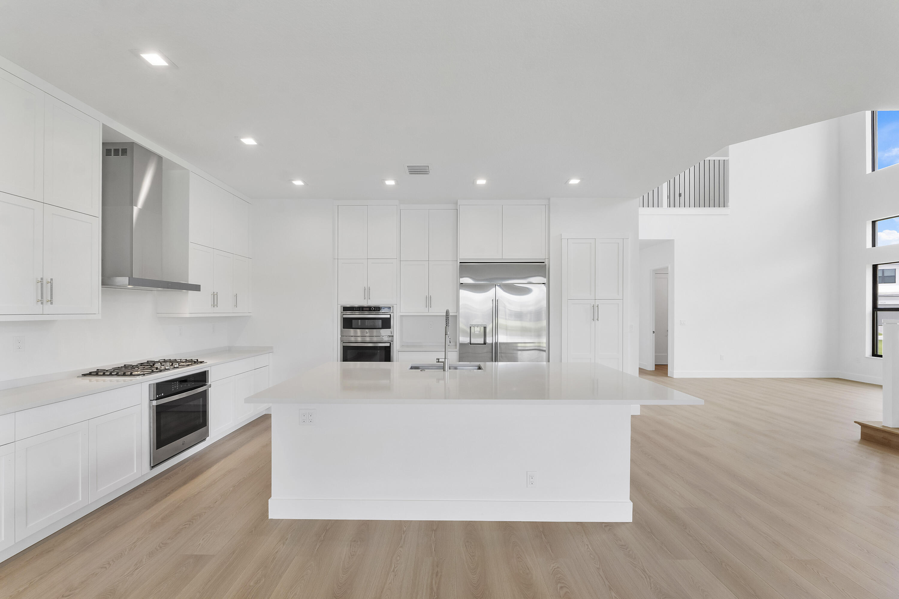9322 Sunflower Mdw Road Boca Raton, FL 33434 - Photo 10 of 87 a large kitchen with stainless steel appliances a large counter top a stove and a refrigerator