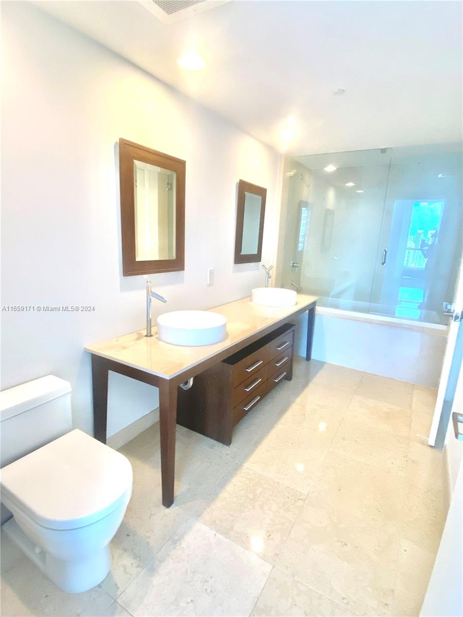 475 Brickell Avenue, Unit 4812 Miami, FL 33131 - Photo 6 of 20 a bathroom with a toilet sink and mirror