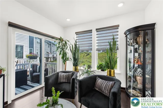 a living room with furniture and a floor to ceiling window