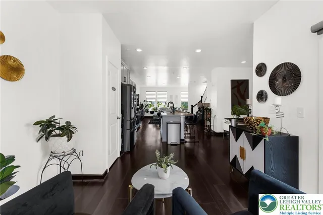 a living room with couches kitchen view and living room view