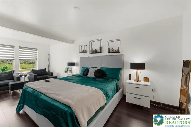 a bedroom with a bed and a large window