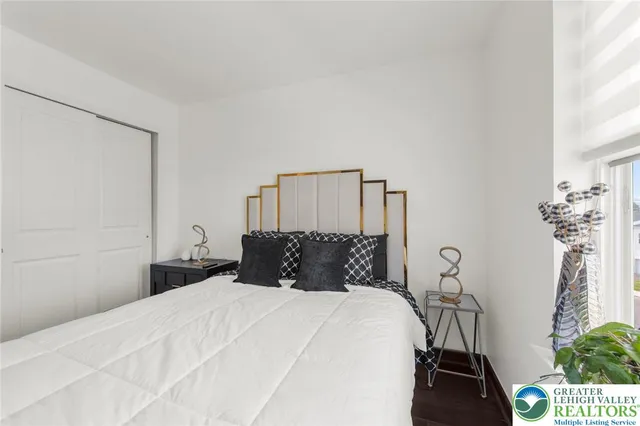 a bedroom with a bed and a potted plant