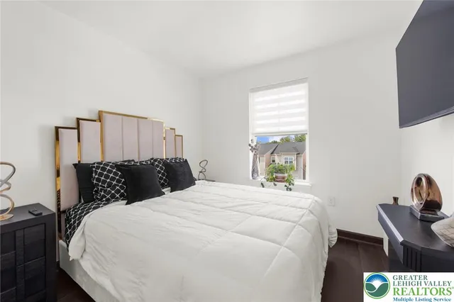 a bedroom with a bed and a window