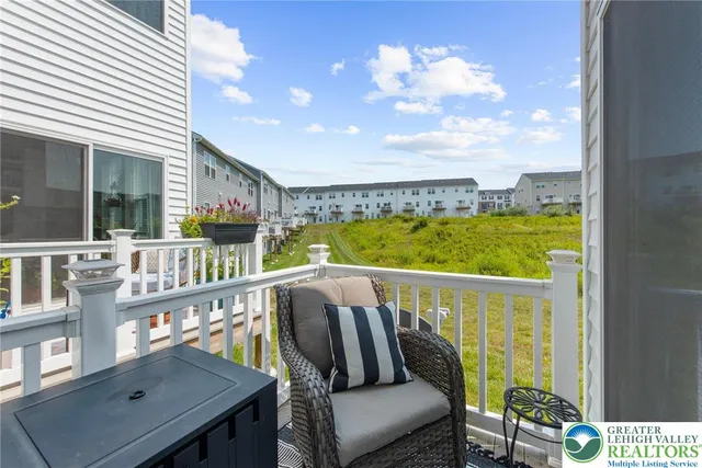 a balcony with wooden floor and outdoor seating