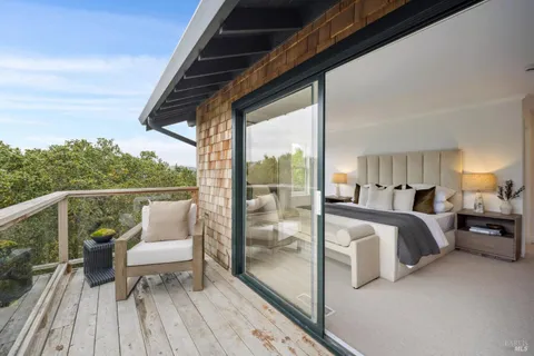 a balcony view with couple of chairs and couch