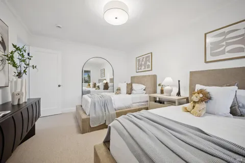 a bedroom with two beds and a large window