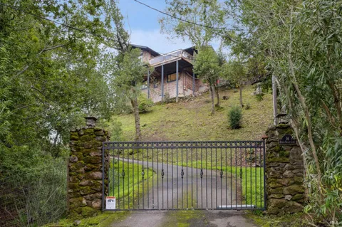 a view of a house with a garage and yard