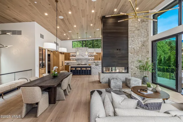 a living room with furniture and a floor to ceiling window