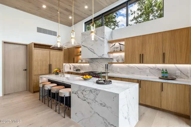 a bedroom with bed and a chandelier