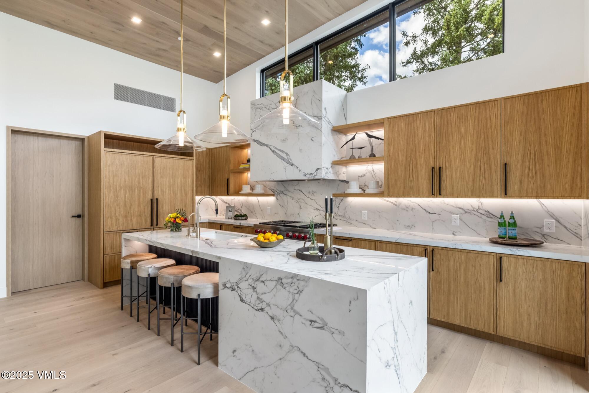 1489 Vail Valley Drive Vail, CO 81657 - Photo 13 of 56 a kitchen that has a lot of cabinets in it and a window