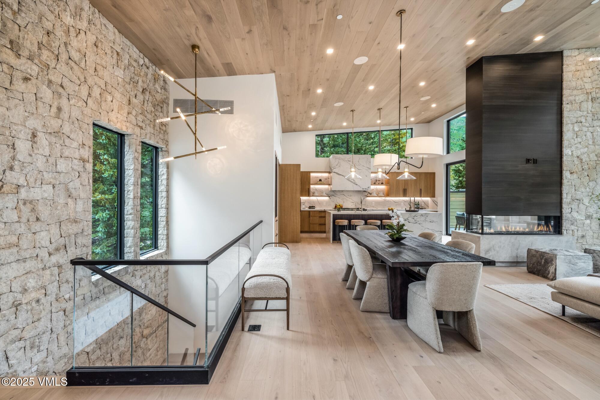 1489 Vail Valley Drive Vail, CO 81657 - Photo 17 of 56 a living room with couches chairs and kitchen view with wooden floor