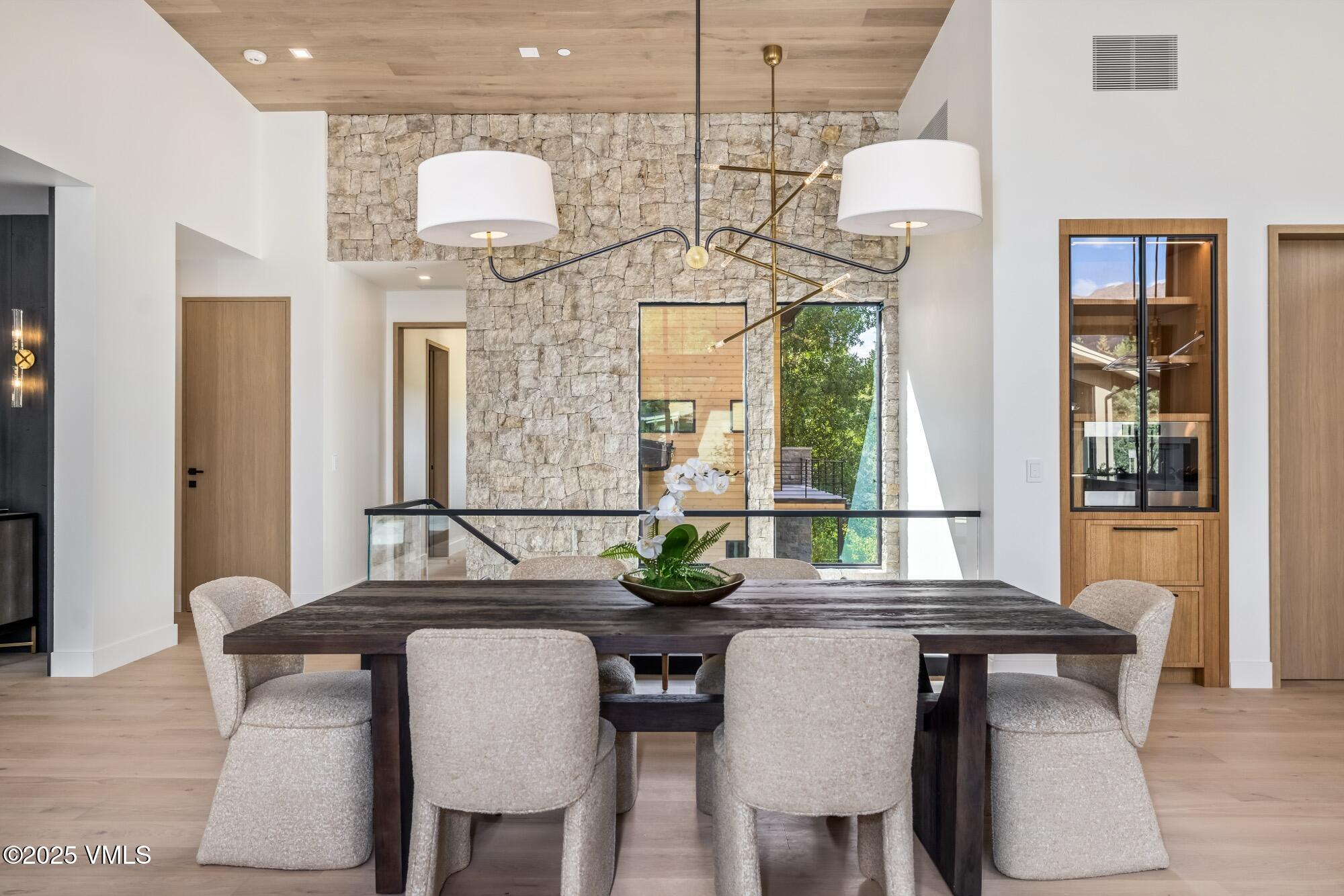 1489 Vail Valley Drive Vail, CO 81657 - Photo 18 of 56 a view of a dining room with furniture and wooden floor