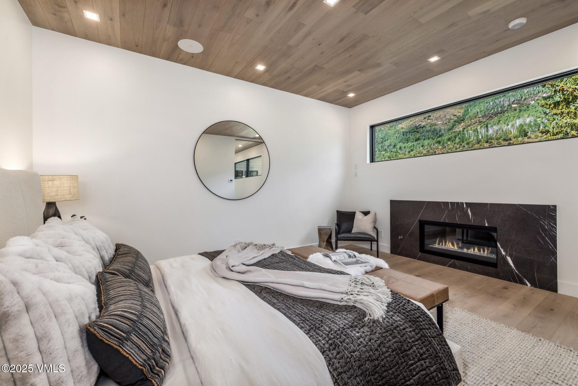1489 Vail Valley Drive Vail, CO 81657 - Photo 21 of 56 a bedroom with a bed and a fireplace