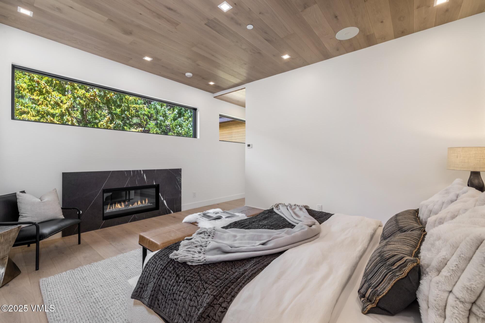 1489 Vail Valley Drive Vail, CO 81657 - Photo 22 of 56 a bedroom with a bed and a fireplace