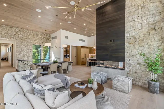 a living room with furniture and a floor to ceiling window