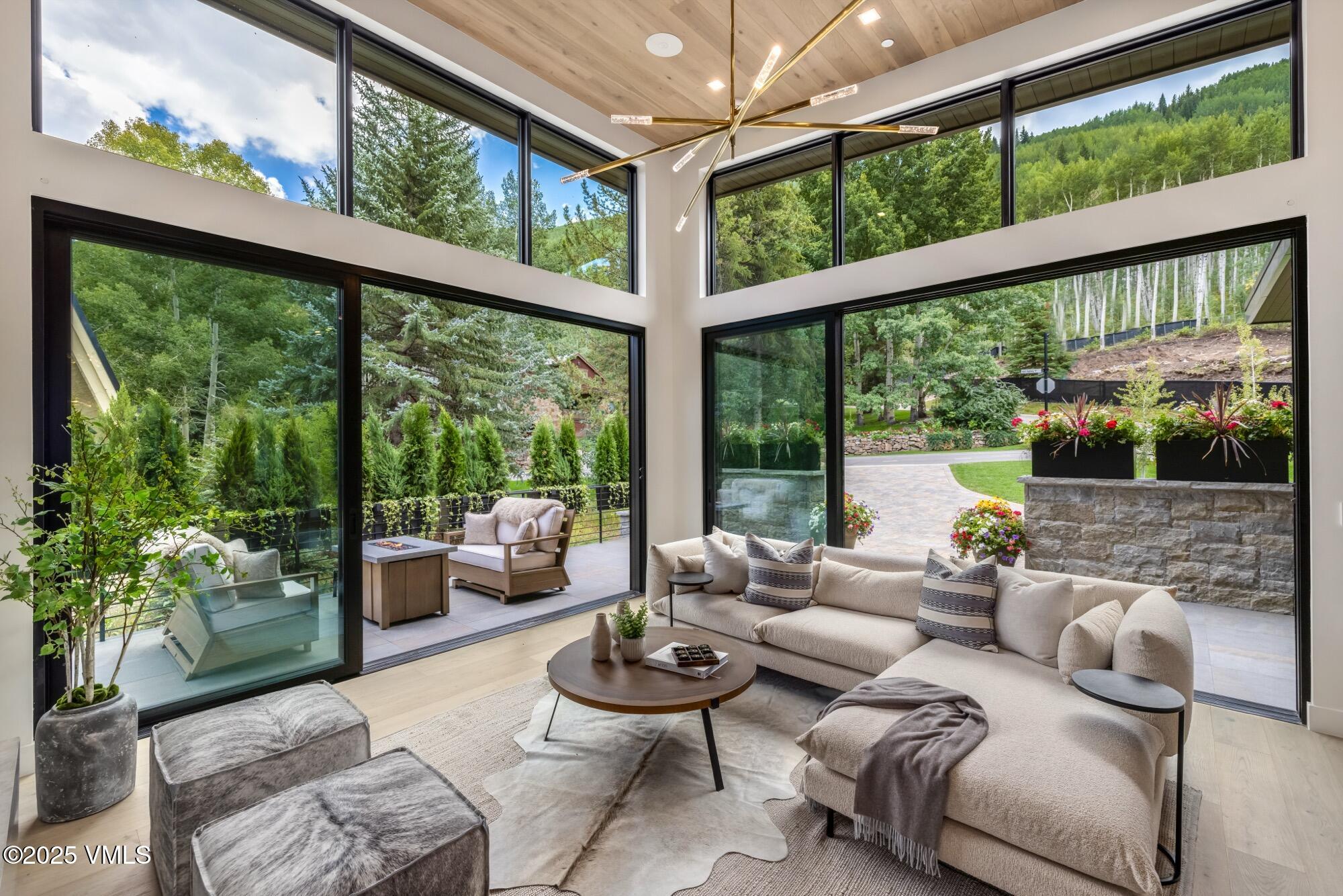 1489 Vail Valley Drive Vail, CO 81657 - Photo 6 of 56 a living room with furniture and a floor to ceiling window