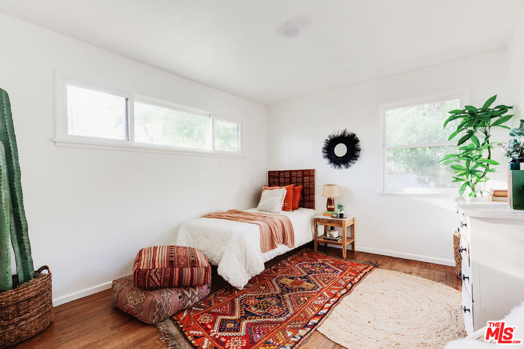 4539 Rising Hill Road Altadena, CA 91001 - Photo 14 of 27 a bedroom with furniture and a potted plant
