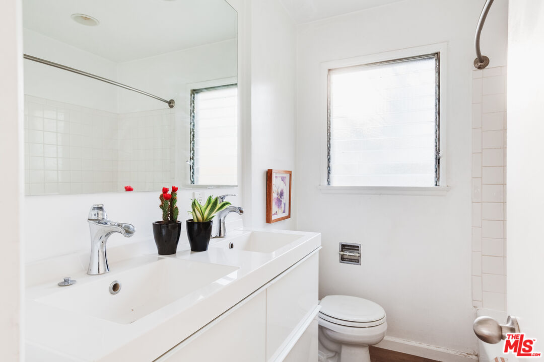 4539 Rising Hill Road Altadena, CA 91001 - Photo 15 of 27 a bathroom with a sink a toilet and a mirror