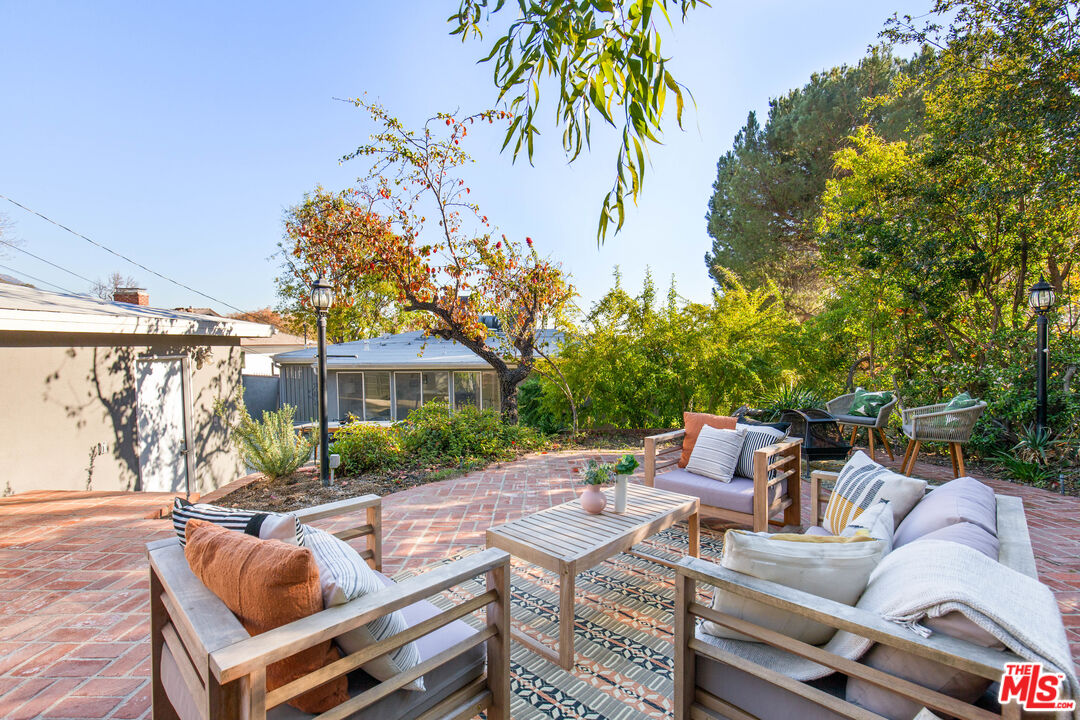 4539 Rising Hill Road Altadena, CA 91001 - Photo 20 of 27 a view of patio with couches table and chairs and potted plants