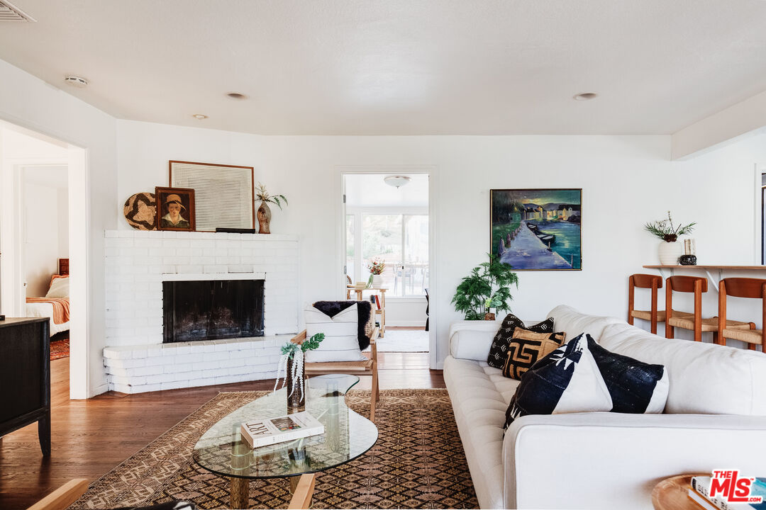 4539 Rising Hill Road Altadena, CA 91001 - Photo 6 of 27 a living room with furniture a fireplace and window