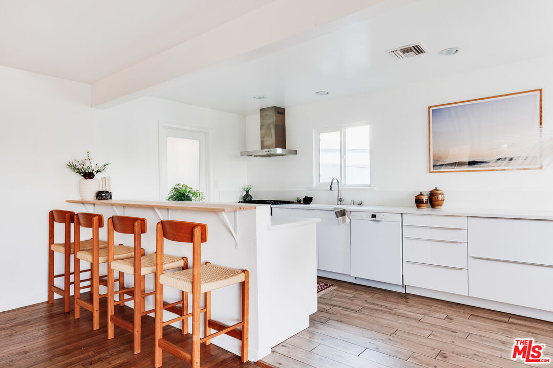 4539 Rising Hill Road Altadena, CA 91001 - Photo 8 of 27 a kitchen with white cabinets and stainless steel appliances