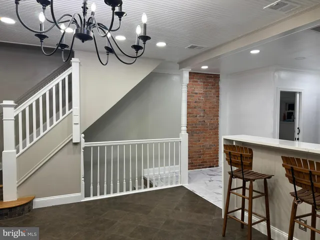 an empty room with wooden floor and cabinet