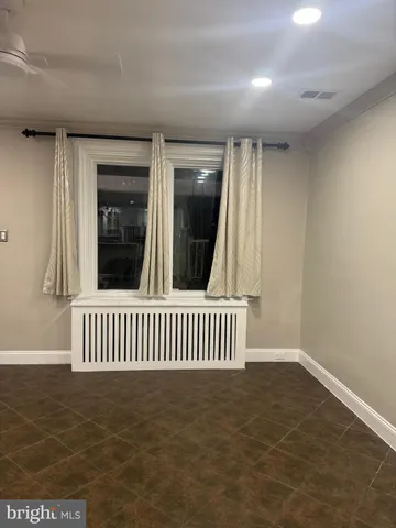 a view of a room with curtain and a wooden floor
