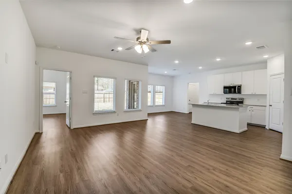 a view of kitchen with sink and wooden floor