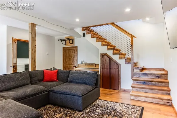 a view of a livingroom with furniture and staircase