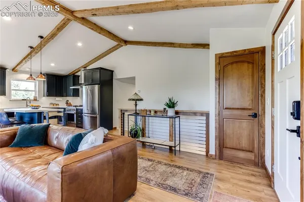a living room with furniture and a kitchen view