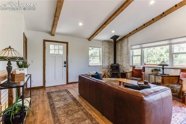 a living room with furniture large window and flat screen tv