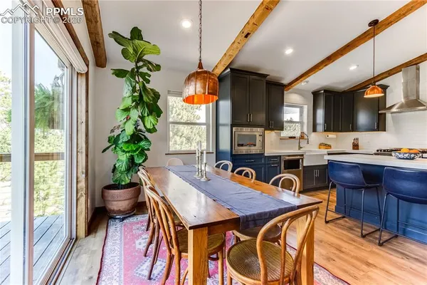 a view of a dining room with furniture window and wooden floor