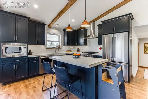 a kitchen with a sink a stove a refrigerator and cabinets