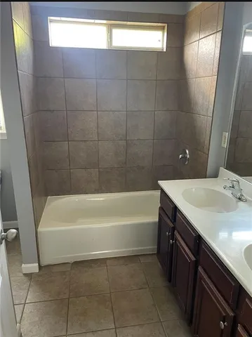 a bathroom with a bathtub and a sink