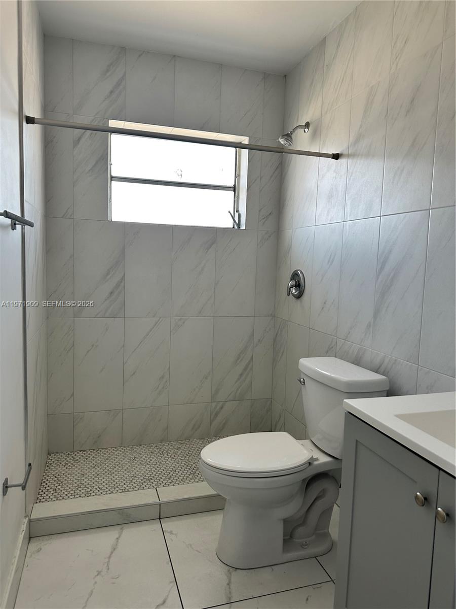 543 Southwest 37th Avenue, Unit 4 Miami, FL 33135 - Photo 7 of 12 a white toilet sitting next to a bathroom sink