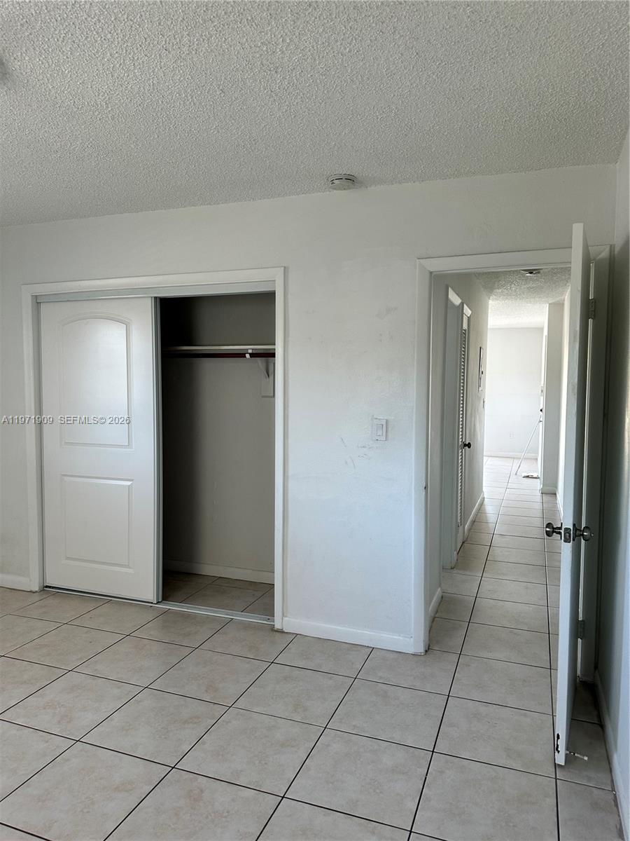 543 Southwest 37th Avenue, Unit 4 Miami, FL 33135 - Photo 10 of 12 an empty room with a bench and closet