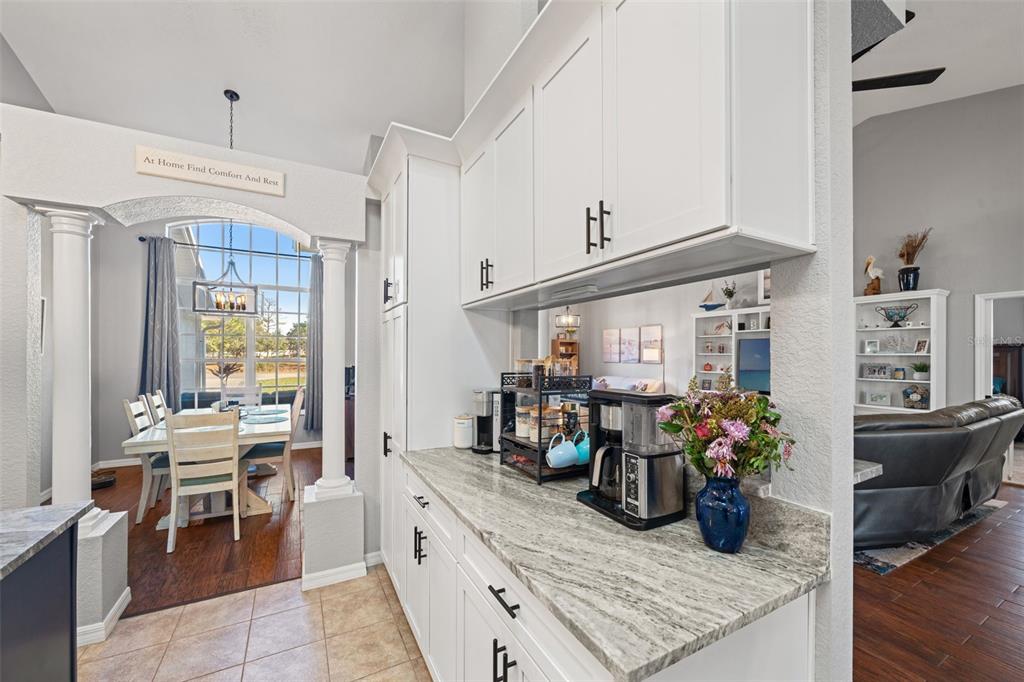 11180 Flock Avenue Weeki Wachee, FL 34613 - Photo 15 of 83 a kitchen with stainless steel appliances kitchen island granite countertop a table and chairs in it