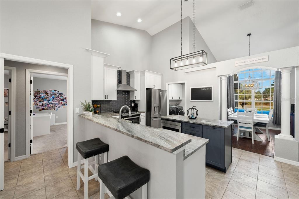 11180 Flock Avenue Weeki Wachee, FL 34613 - Photo 17 of 83 a kitchen with kitchen island granite countertop a sink counter top space appliances and a window