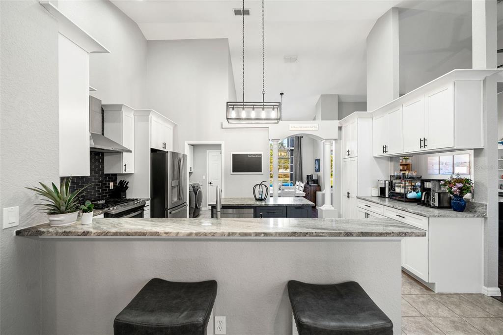 11180 Flock Avenue Weeki Wachee, FL 34613 - Photo 18 of 83 a kitchen with counter top space cabinets and stainless steel appliances