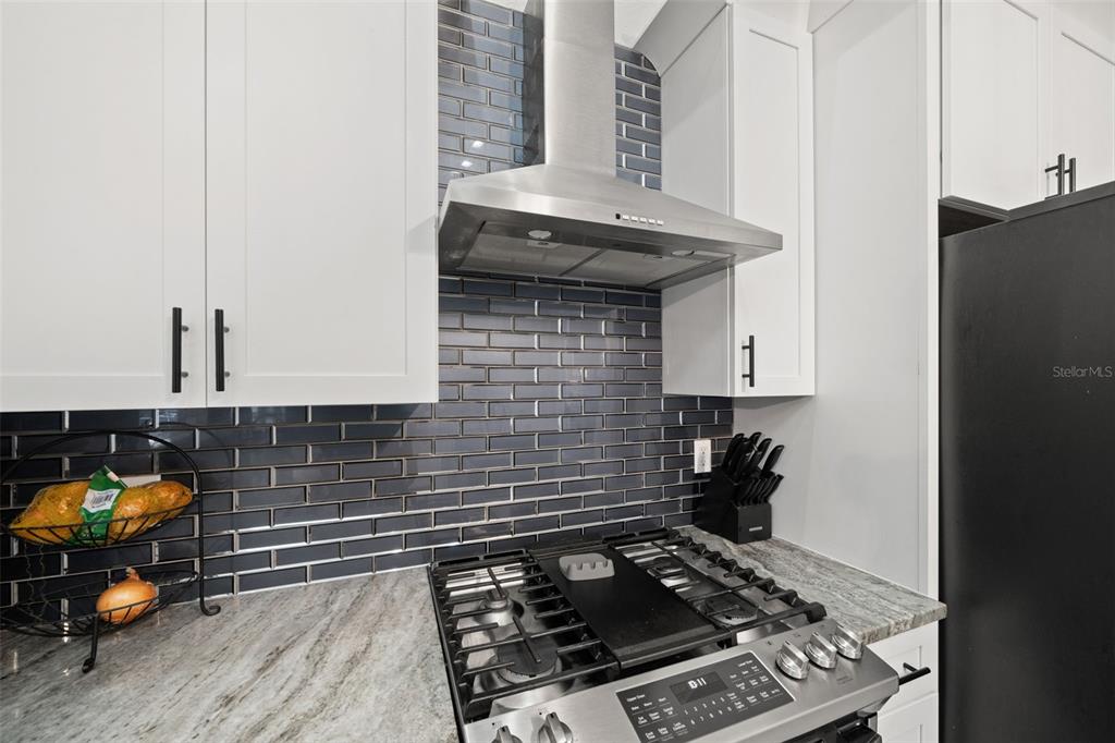 11180 Flock Avenue Weeki Wachee, FL 34613 - Photo 22 of 83 a kitchen with a stove and a refrigerator