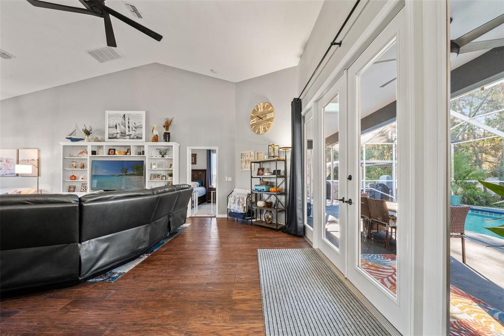 11180 Flock Avenue Weeki Wachee, FL 34613 - Photo 27 of 83 a living room with furniture a large window and a fireplace