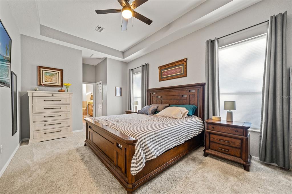 11180 Flock Avenue Weeki Wachee, FL 34613 - Photo 33 of 83 a bedroom with a bed and a chandelier