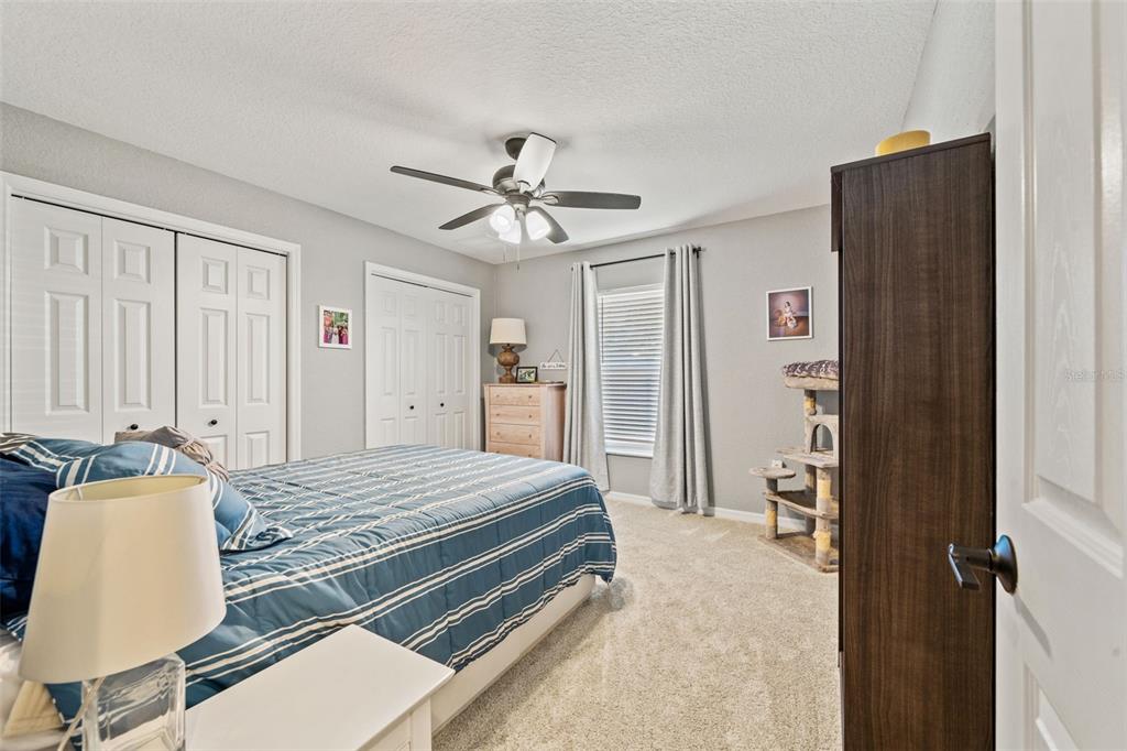 11180 Flock Avenue Weeki Wachee, FL 34613 - Photo 43 of 83 a bedroom with a bed and a chandelier