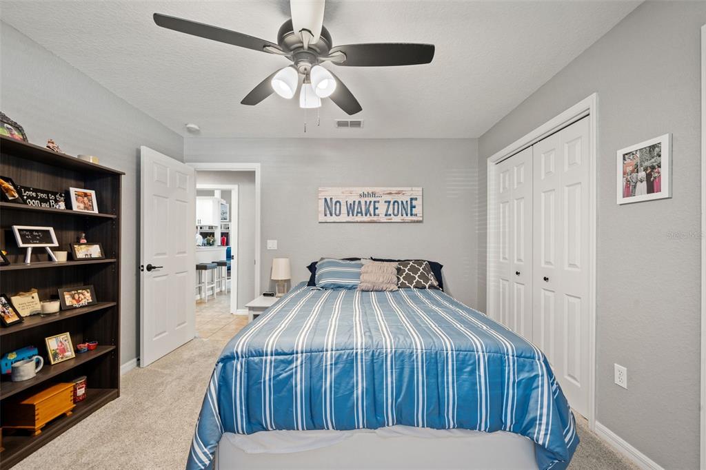 11180 Flock Avenue Weeki Wachee, FL 34613 - Photo 44 of 83 a bedroom with a bed and a book shelf